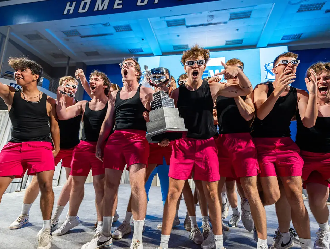 Students celebrating talent contest victory.