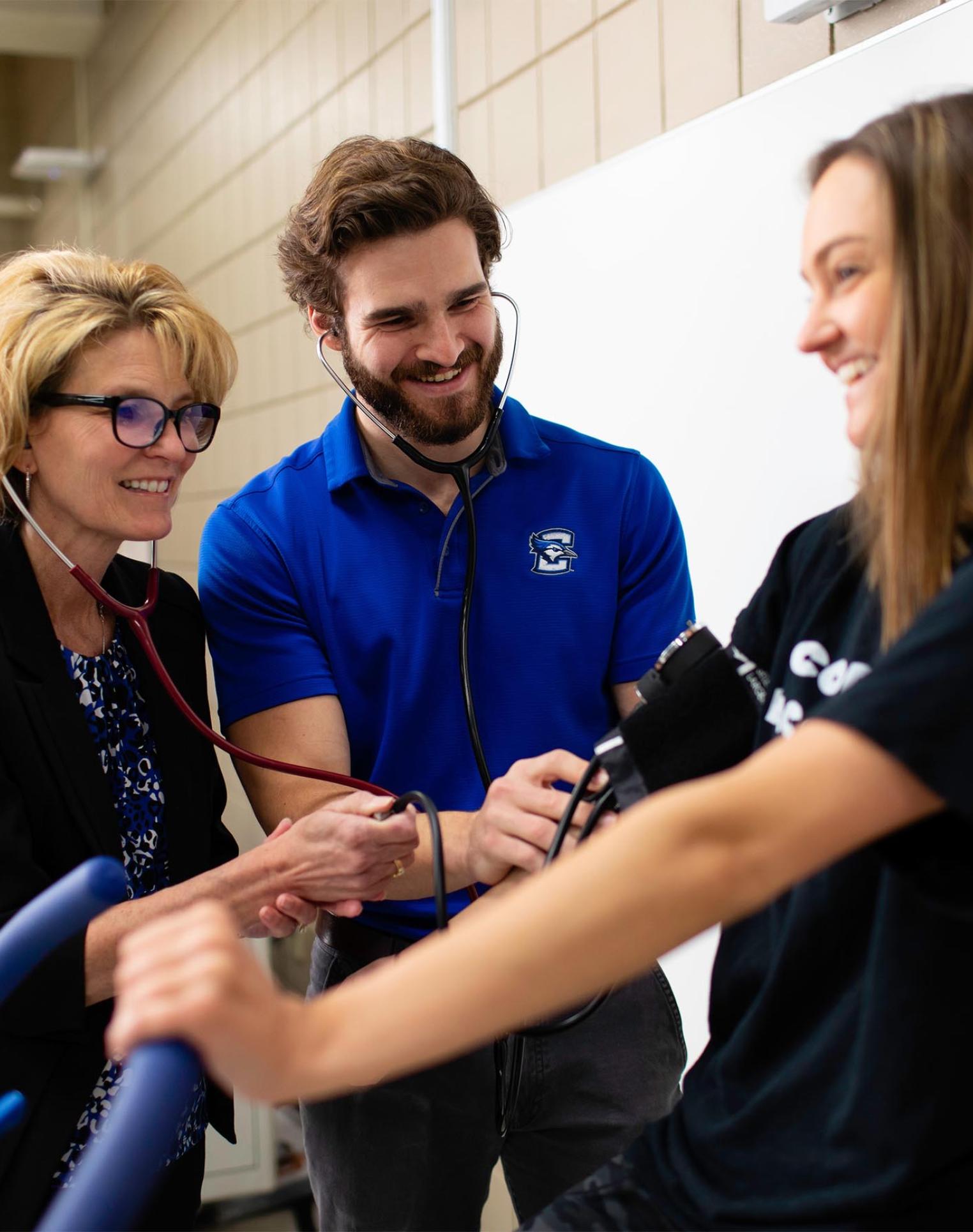 Creighton health sciences students doing hands-on learning with faculty