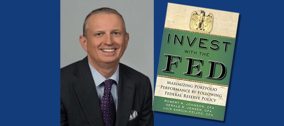 Robert Johnson with his book Invest with the Fed