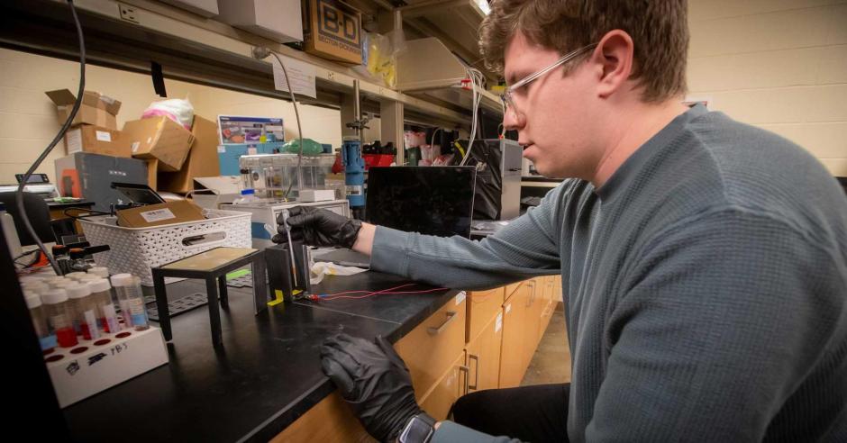 Patrick Herchenbach doing research in a lab at Creighton University