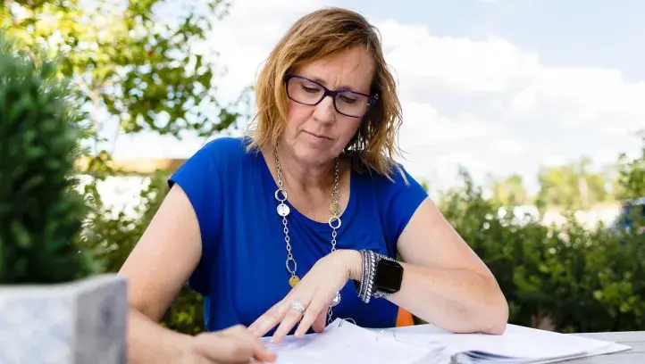 Woman working at table outside