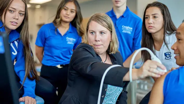 PT students and faculty in lab