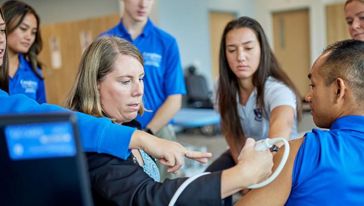Physical therapy students learning from facutly