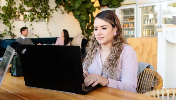 women on laptop at table