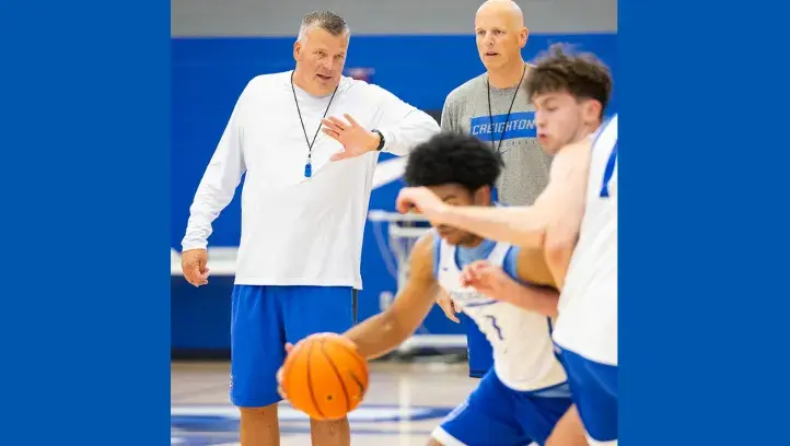 Greg McDermott and Alan Huss coaching basketball practice