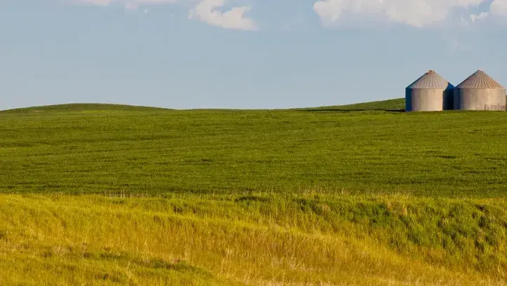 Rural landscape with grain storage units.