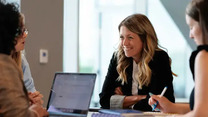 Manager's brainstorm around table.
