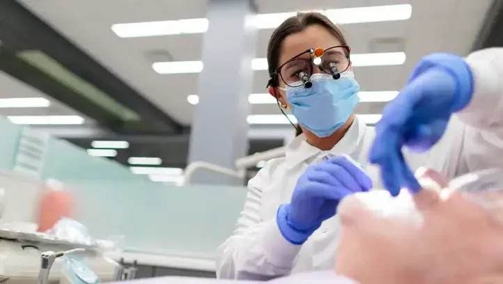 Dentist working on patient at Creighton.