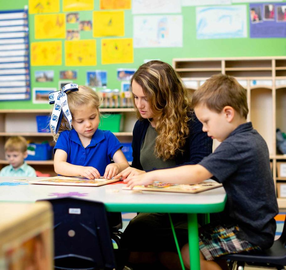 Teacher with elementary students in classroom Thumbnail