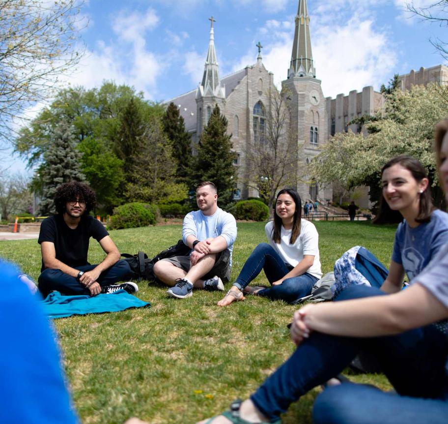 Students sitting outdoors on Creighton's campus