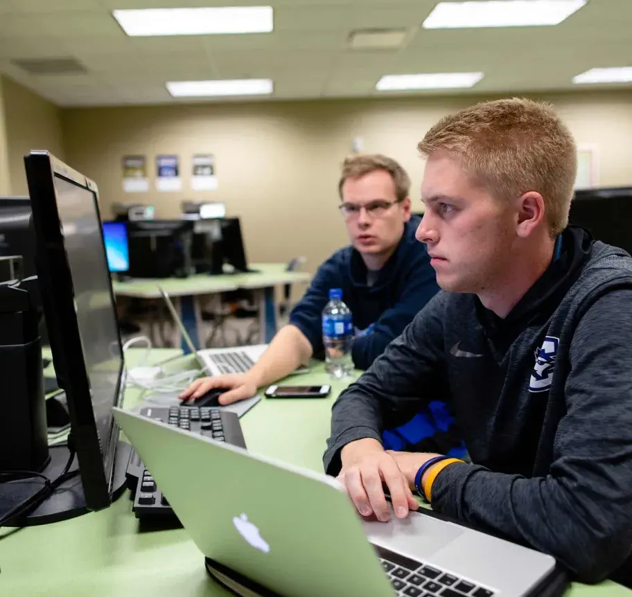 Two students working at computers
