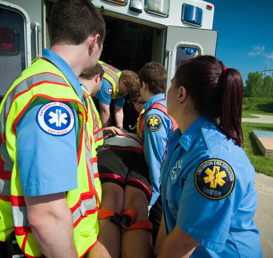 EMS students loading patient into ambulance