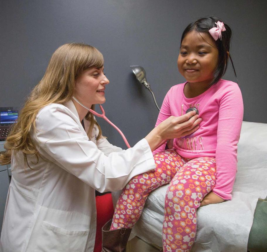 Doctor of medicine student examining a child