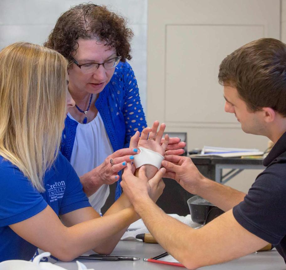Occupational therapy students learning from faculty