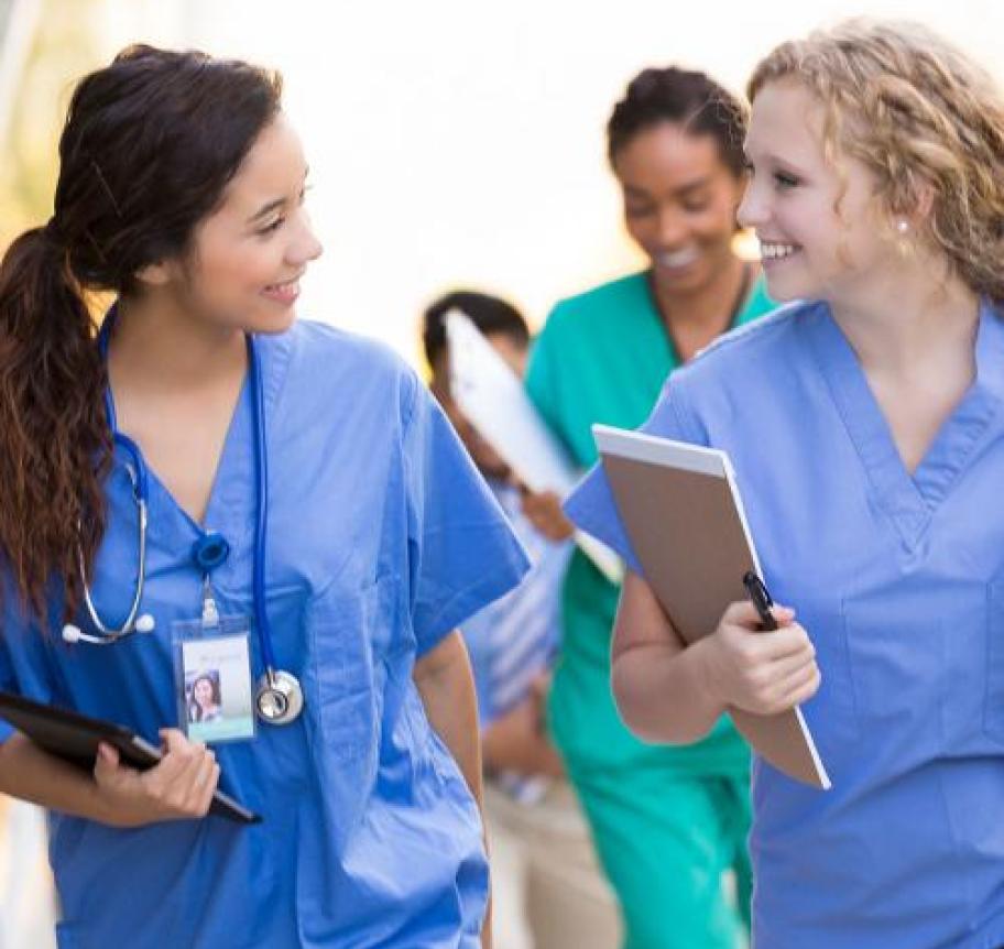 A group of nurses holding paperwork