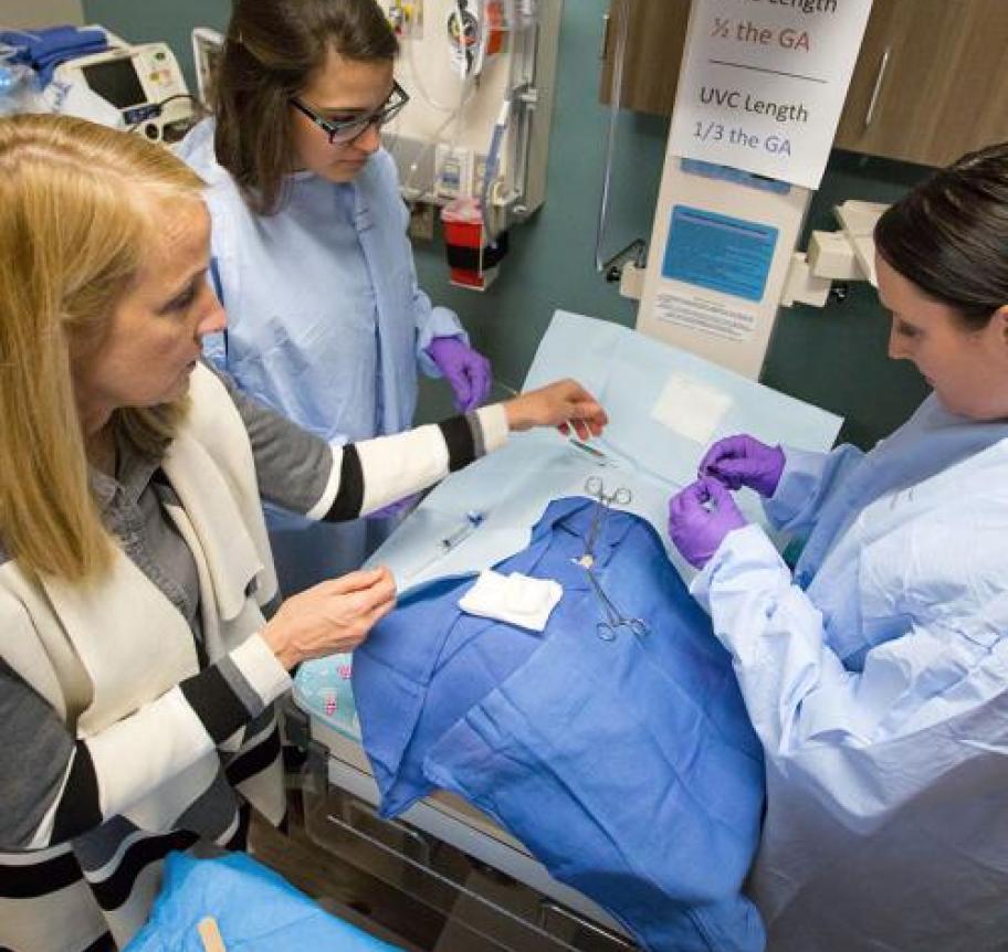 Nurses performing a procedure on a patient