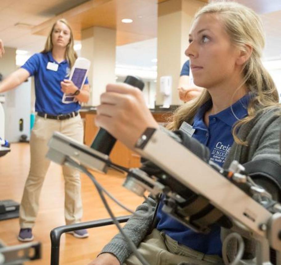 An occupational therapist helps a patient through an exercise