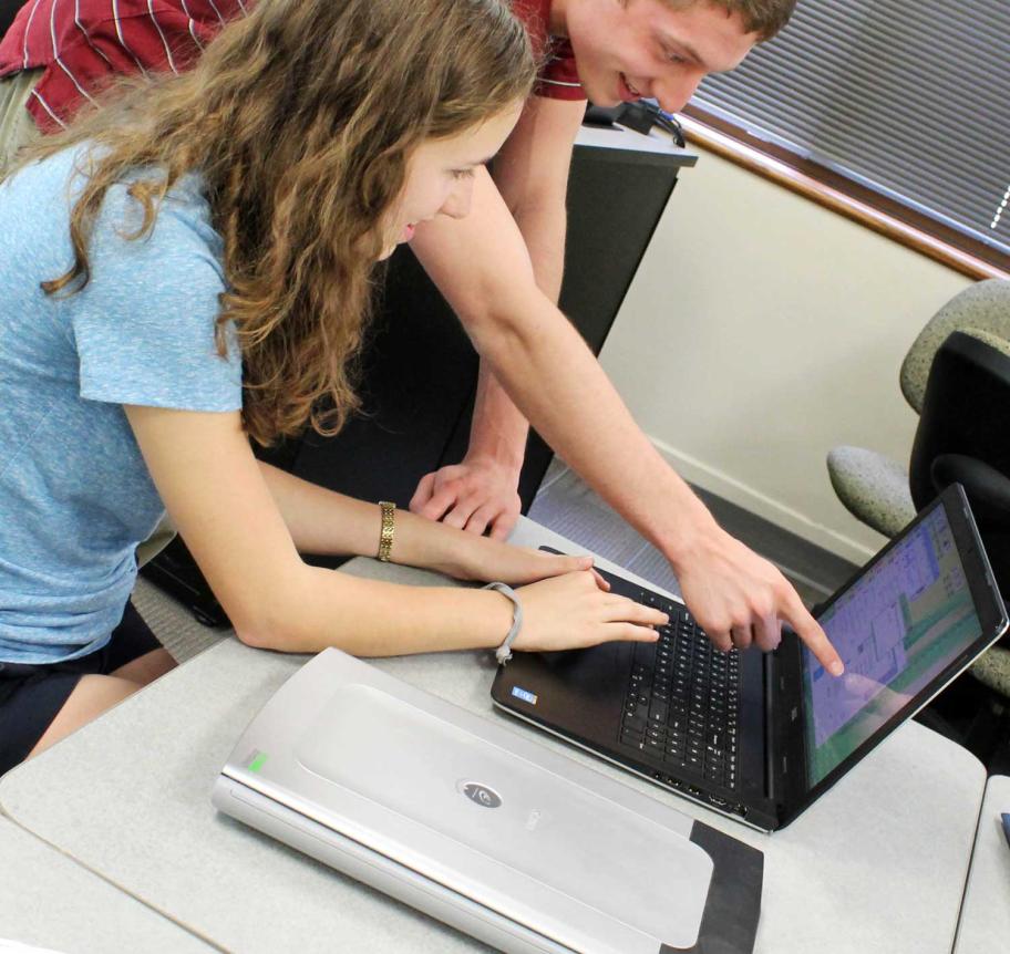 Students working together at laptop