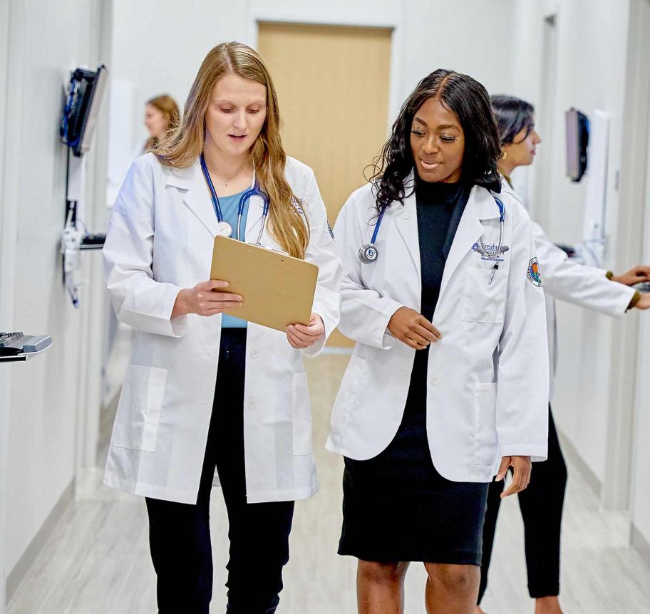 Physician assistant students walking in hall