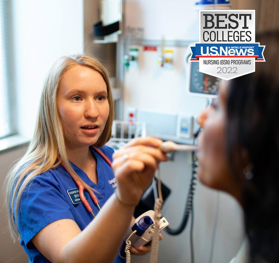 Nursing student taking temperature with Best Colleges U.S. News & World Report badge for 2022