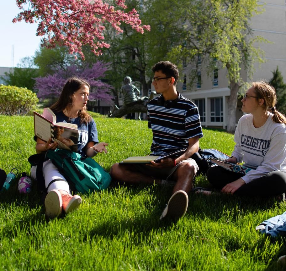 Students gathered in a grassy area outdoors