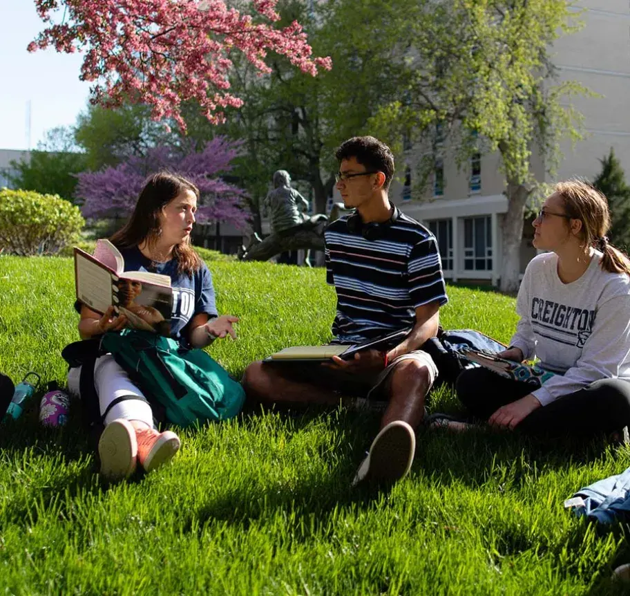 Students gathered in a grassy area outdoors