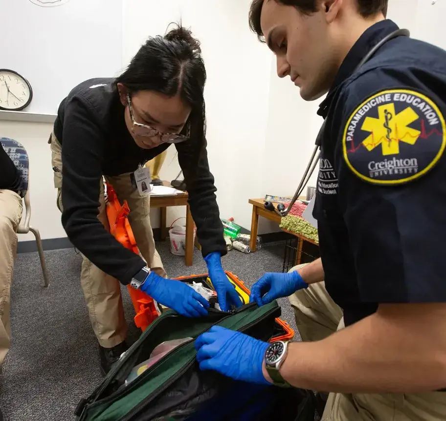 Paramedic students training on medical equipment