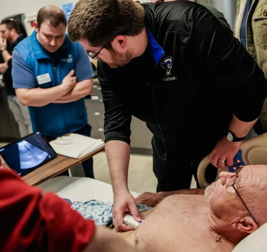 Paramedic performing ultrasound on patient.