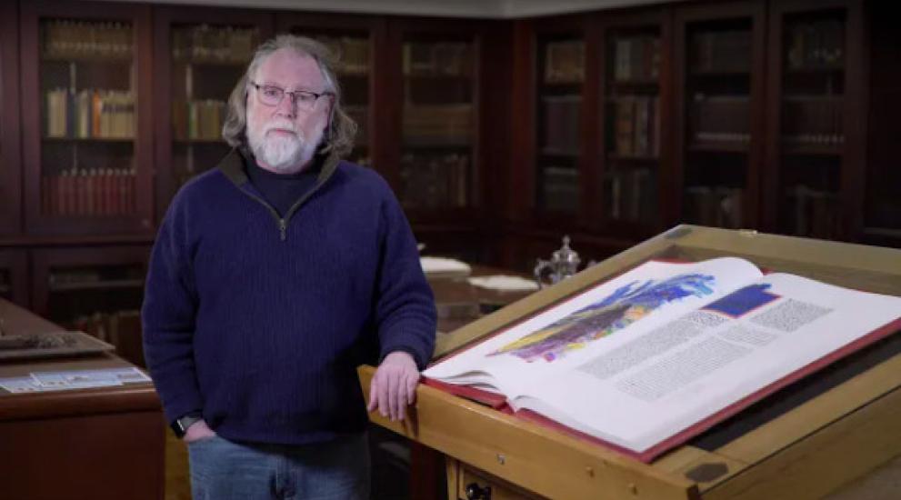Video thumbnail featuring John O'Keefe next to the St. John's Bible