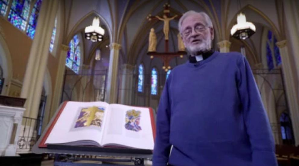 Video thumbnail featuring Rev. Dennis Hamm next to the St. John's Bible