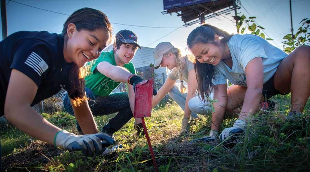 A group of students planting a garden.