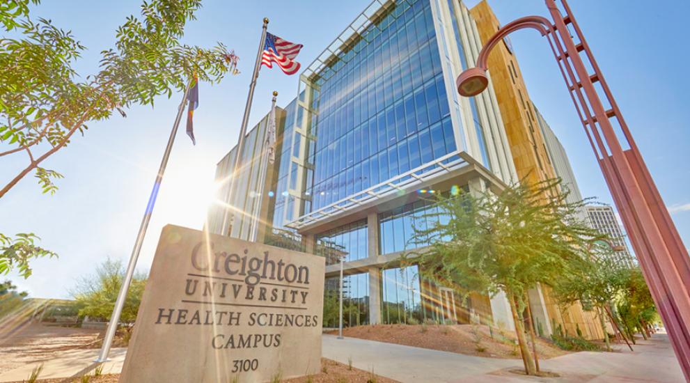 Creighton Health Sciences Campus building with sun beaming over one side.