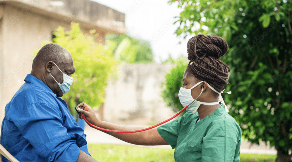 image of african man with face mask, braided black woman in face mask holding stethoscope- home health care concept