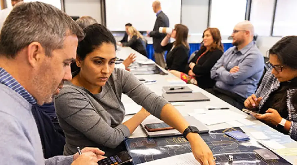 Adult students working together on project