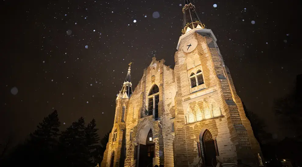 Exterior night view of lit St. John's church.