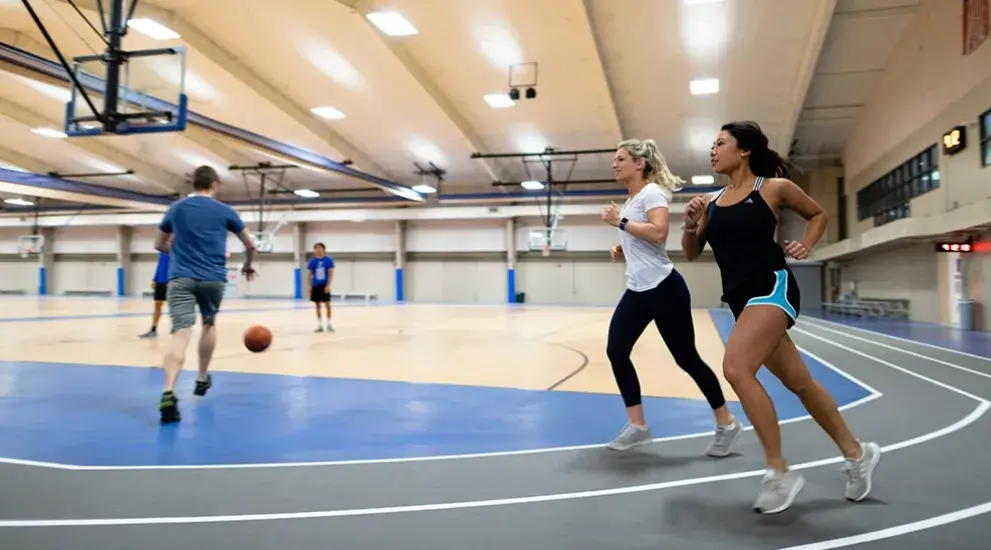Students running on indoor track