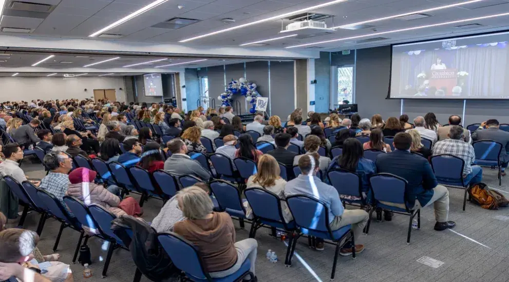 Norton Ballroom filled with rows of chairs and people.