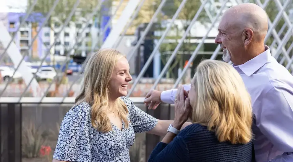 People celebrating at Phoenix campus event.