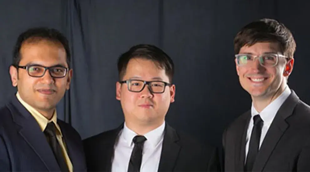 2019 General Surgery Residency graduation photo featuring three residents in business formal attire celebrating their program completion.