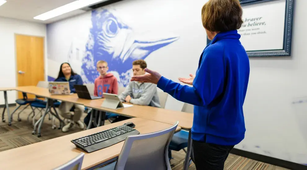 Faculty and students working together in class