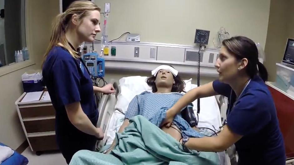 Nursing students working in simulation patient room