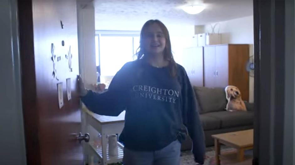 Student showing tour of Kenefick Hall room.